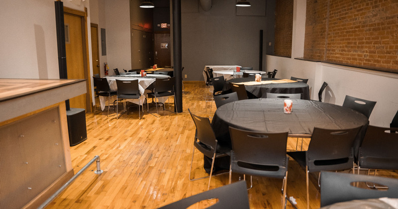 Interior, round dining tables ready for guests