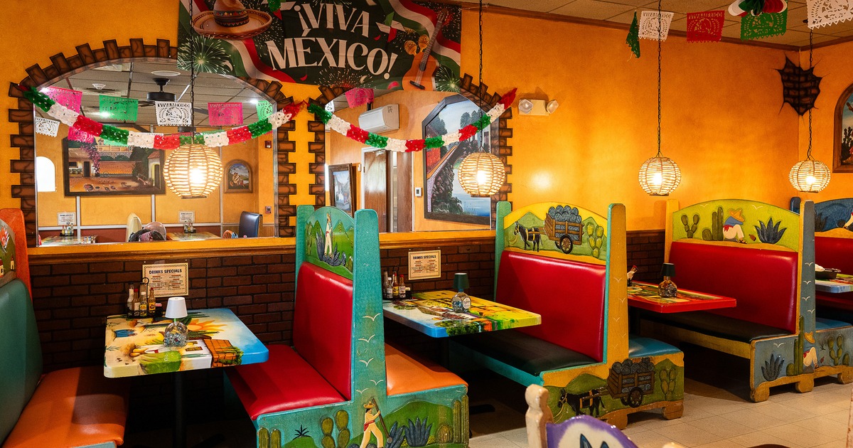 Vivid and cozy Mexican-style interior dining area with colorful dining booths along the wall