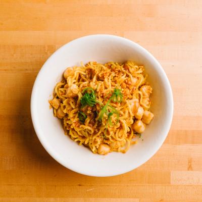 Scallop noodles in a bowl with garnish.