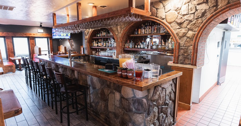 Bar with stone and wood accents, and a variety of drinks