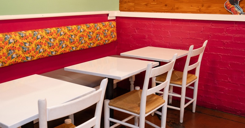 Lined up white tables and chairs