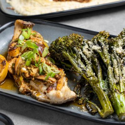 Chargrilled redfish filet dish, served with broccolini.