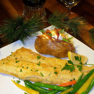 Fish served with loaded baked potato, steamed veggies and white wine.