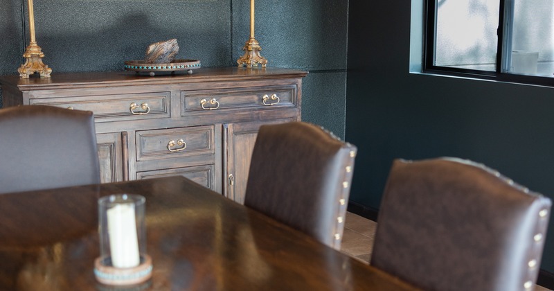 Interior, elegant dining space with wooden furniture and leather chairs
