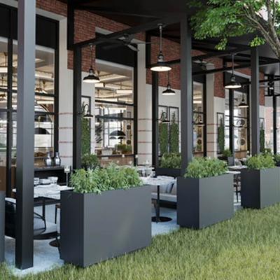 Outdoor patio with metal planters, tables, chairs and hanging lights.
