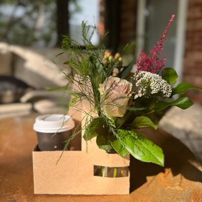 Mini bouqet and coffee served outside in the sun.