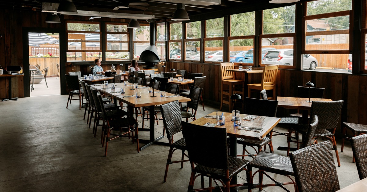 Dining area with wooden furniture and large windows