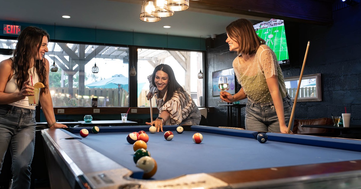 A group of friends enjoying a game of pool