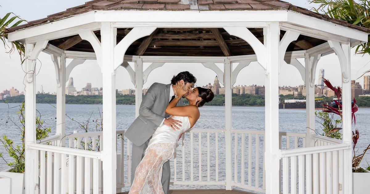 Bride and groom kissing inside the gazebo