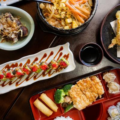 Assorted food plates spread on a table, top down view.