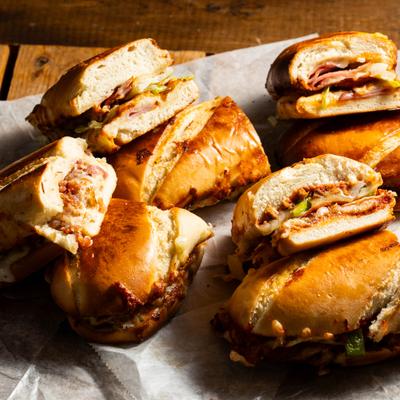 Various sandwiches cut in half and served, top view.