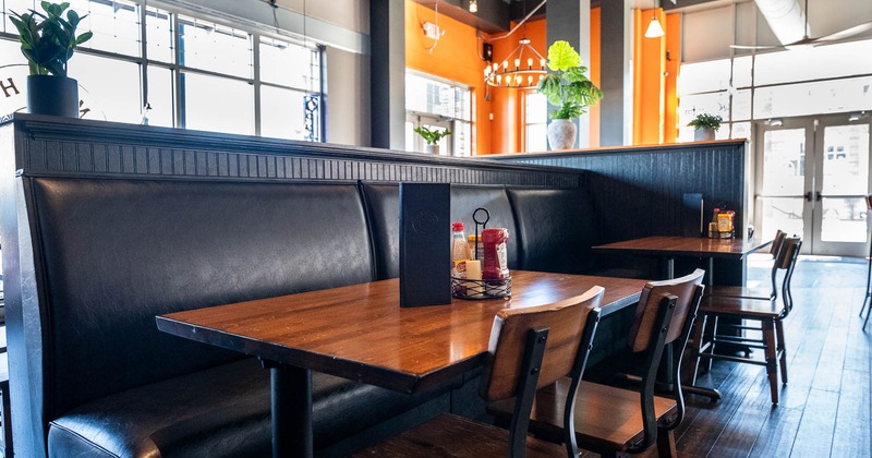 Interior, black leather booths, tables and chairs