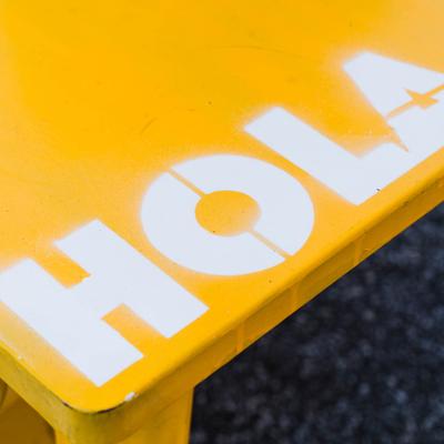 Restaurant signage in white on a yellow table.