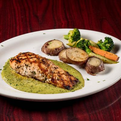 Grilled salmon in a pesto sauce served with veggies.