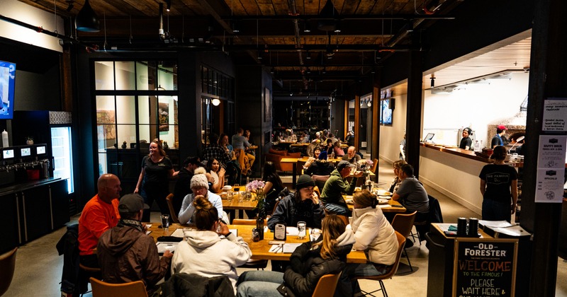 Cozy interior with tables and chairs, filled with people