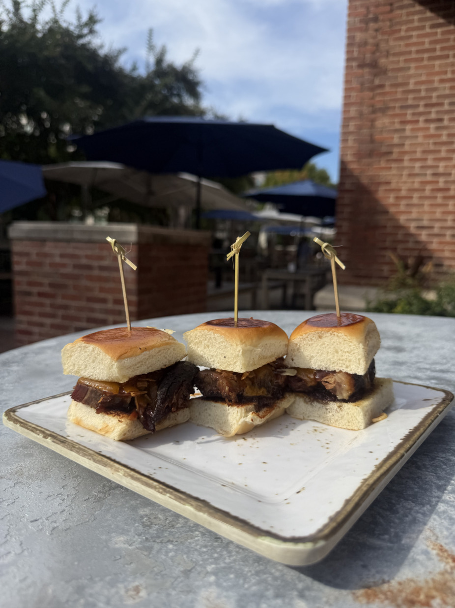 Brisket Slider - Smoked brisket, aged cheddar, bourbon bacon jam, and crispy onions on Hawaiian rolls