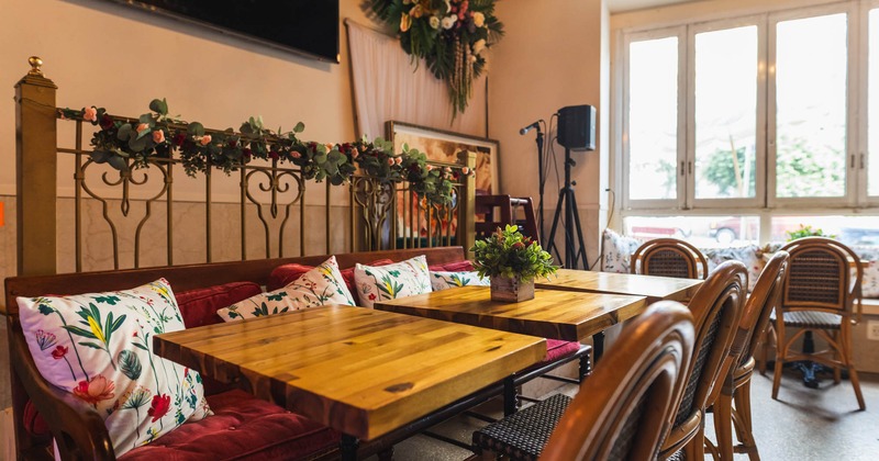 Three small tables with chairs and wooden sofa