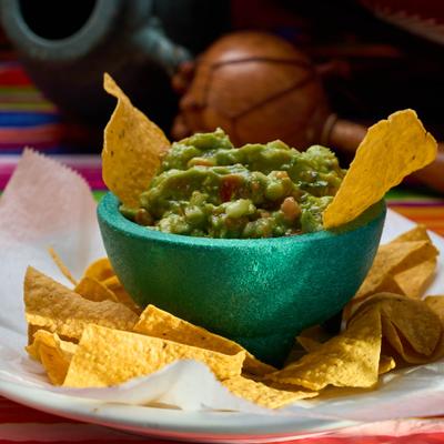 Chucky guacamole with tortilla chips.