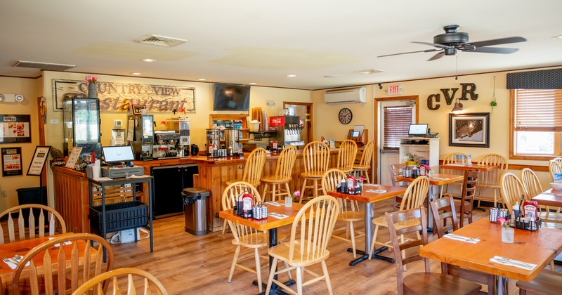 Diner area, tables, chairs, food counter behind