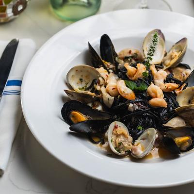 Squid Ink Linguini and Mixed Seafood, served, top view.