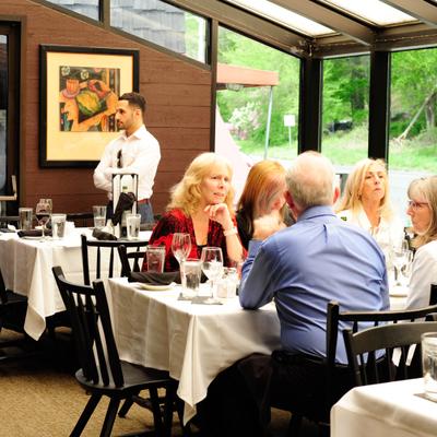 View at dining area with people siting at tables.