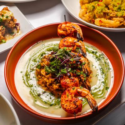 Wood Grilled Shrimp skewer and paella, with jalapeno and cilantro pesto sauce.