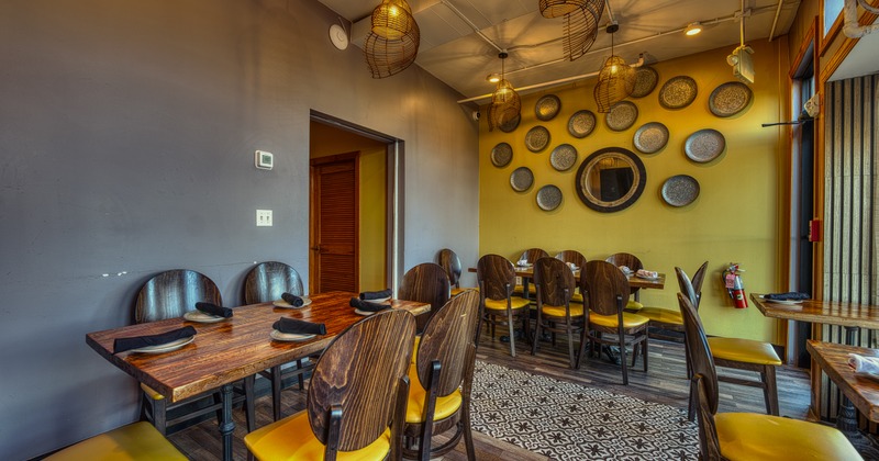 Interior, dining space with decorative plates on the yellow wall