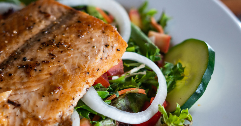 Grilled salmon atop Garden salad