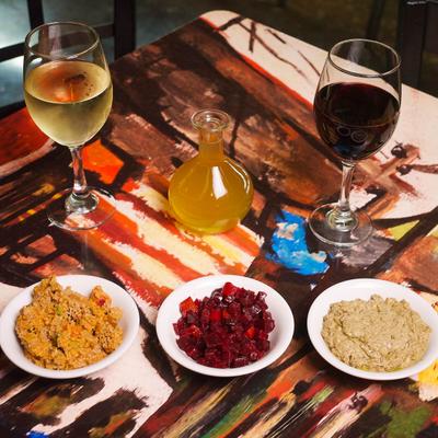 Various menu items served on the table with two glasses of wine.