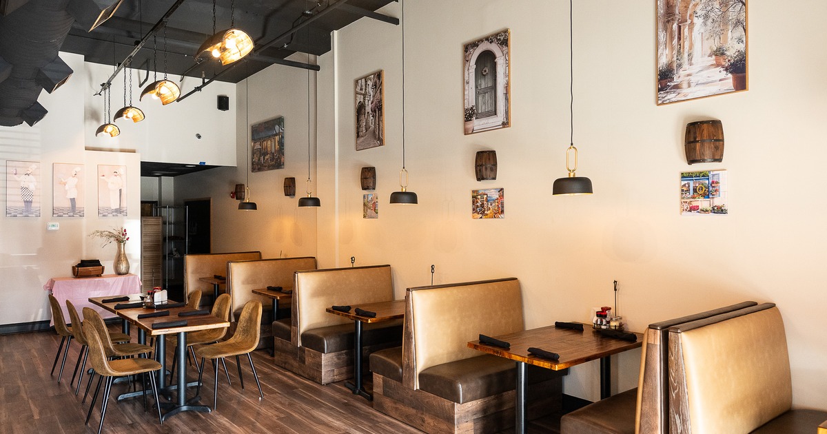 Cozy and modern interior dining area with upholstered booth seats and a long dining table