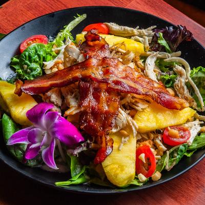 Salad with mixed greens, bacon, chicken,pineapple, tomato, macadamia nuts.