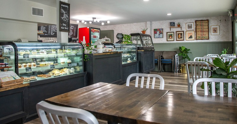 Interior, tables and chairs near food display