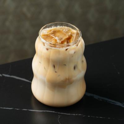 Iced coffee in a curved glass.