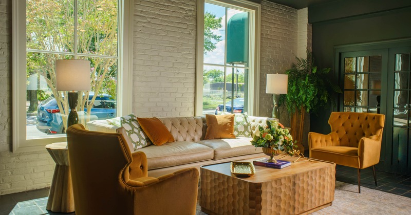 Interior, lounge area, comfy three-seater sofa with armchairs and coffee table