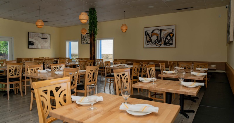 Interior, dining area, wooden top tables with chairs, banquette bench with tables and chairs