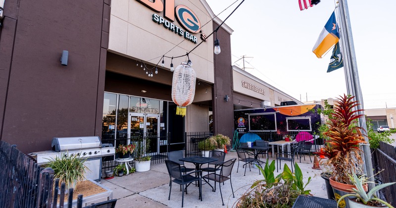Outdoor seating area in front of the sports bar entrance