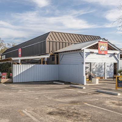 Exterior with signage and an empty parking lot