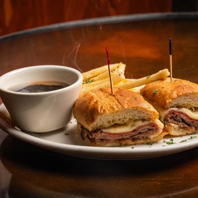 French Dip sandwich, with fries and au jus.