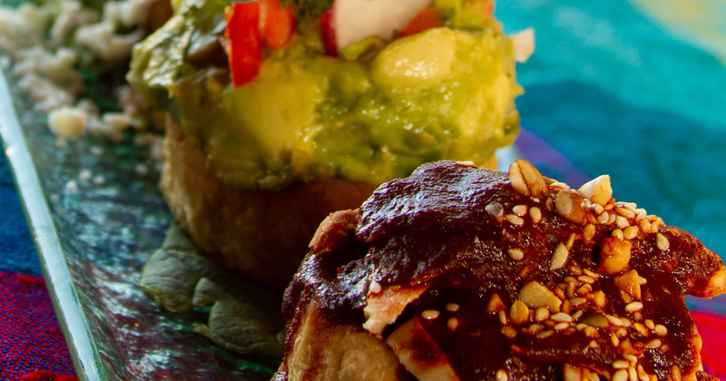 Close-up of two sopes on a colorful tablecloth