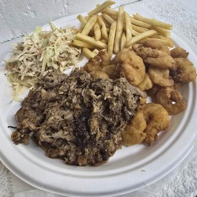 Boss Hog Surf and Turf with pulled pork, popcorn shrimp, fries and coleslaw.