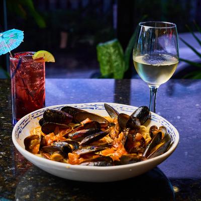 Mussels in marinara, accompanied with white wine and vodka cranberry.