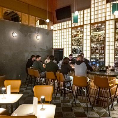 Interior, seating area, patrons sitting at the bar.
