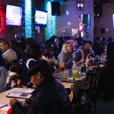 Customers sitting at the bar.