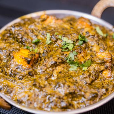 Palak Paneer garnished with chopped cilantro.