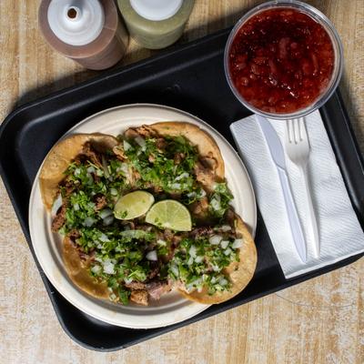 Pork tacos, with onions, cilantro, and salsa.