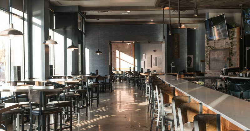 Interior, front view of dining area, bar area on the right