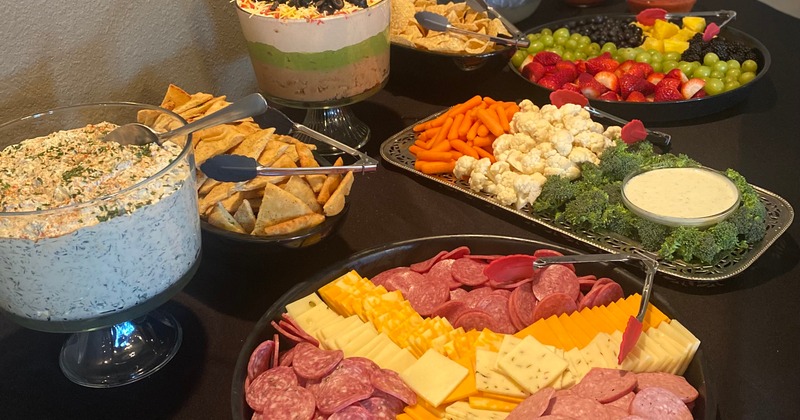 A close up of a table with assorted catering dishes