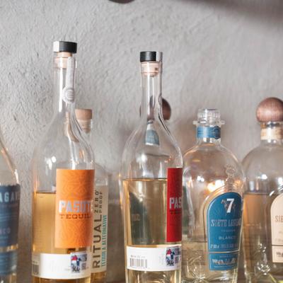 Assorted tequila bottles displayed on a shelf.
