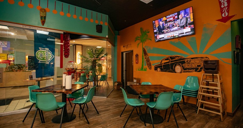 Interior, seating area, tables and chairs, TV on the wall