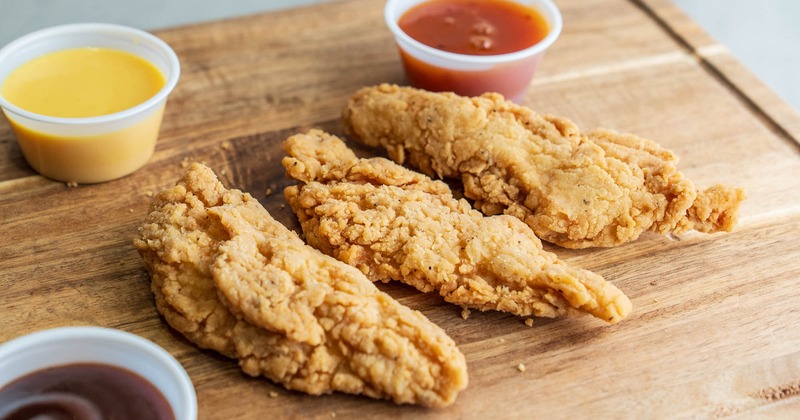 Fried chicken strips with sauces for dipping